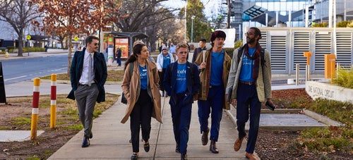 Young Ambassadors walking together on the street