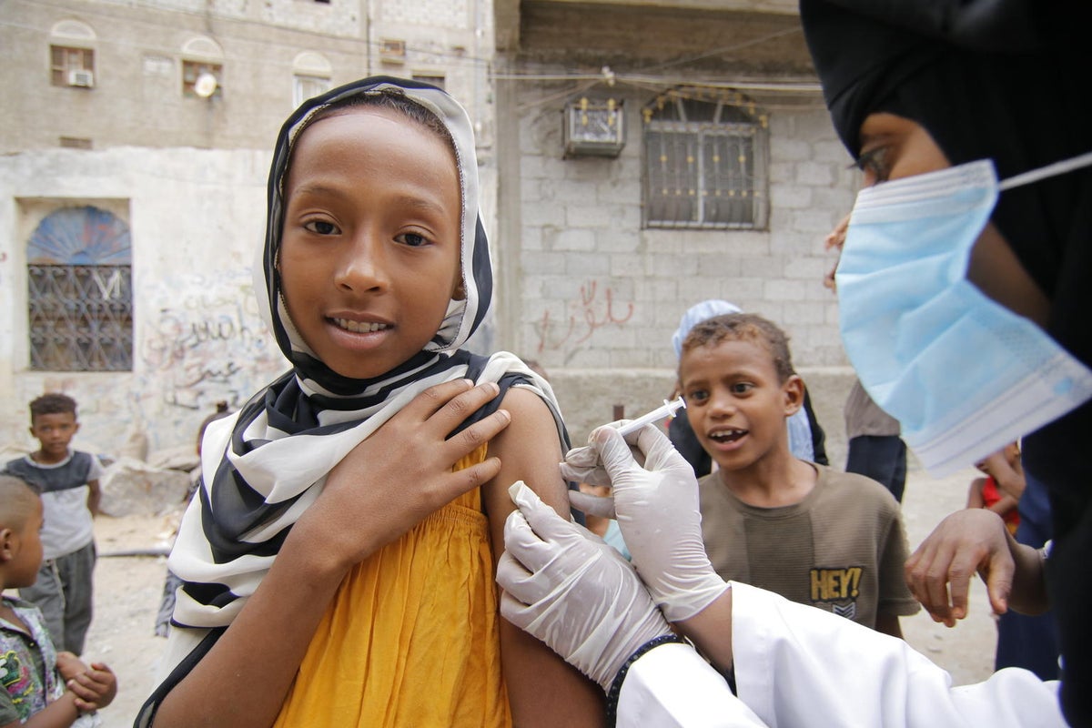 A young girl receives a vaccine