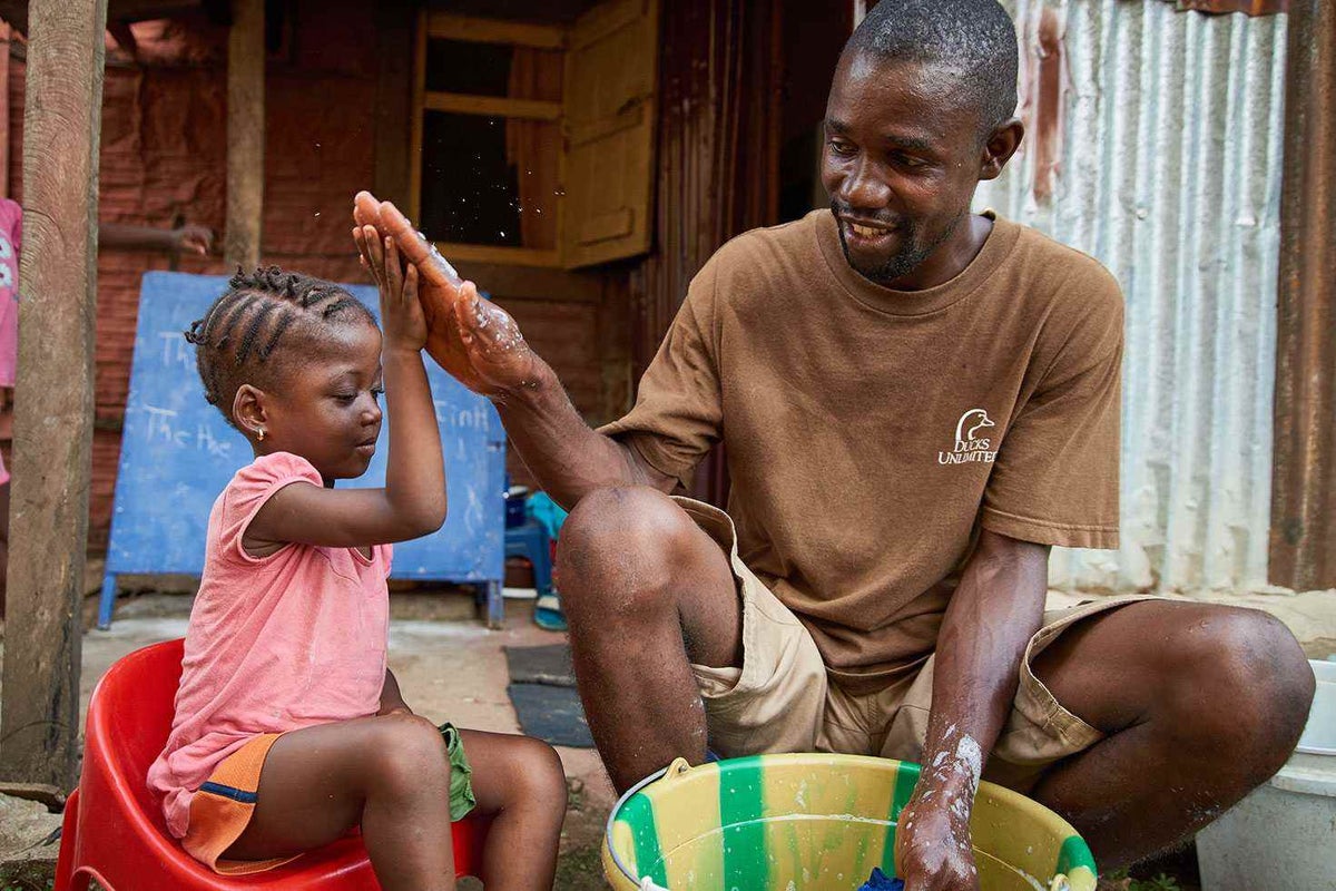 Tamba turns doing the washing into a moment to bond with his three-year-old, Annie. 