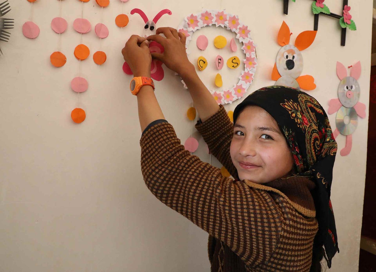 A young girl has fun creating crafts at a Child Friendly Space in a northern province of Afghanistan.
