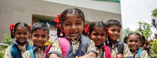 A group of smiling young students in India.