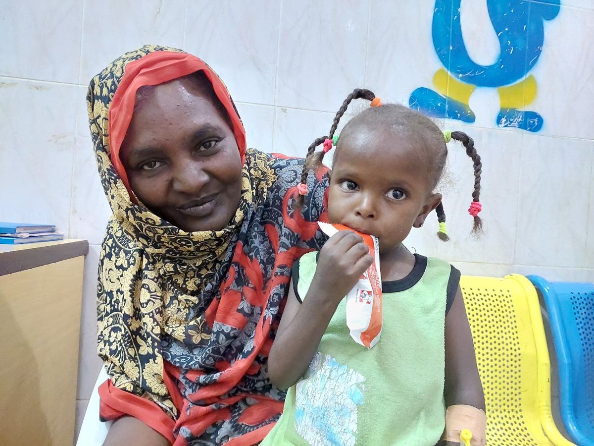 A three year old eating ready-to-use-therapeutic food (RUTF) as she receives treatment for severe acute malnutrition in hospital in Sudan