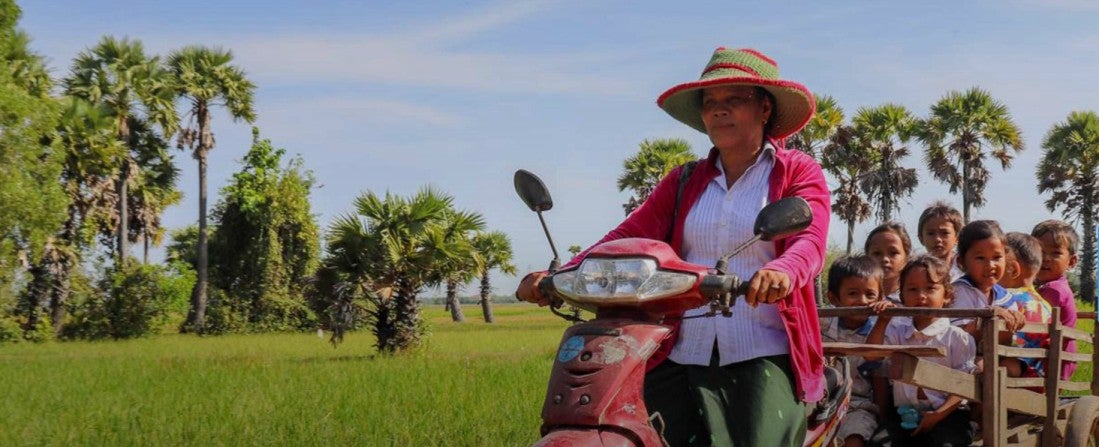 A teacher drives to students in Cambodia