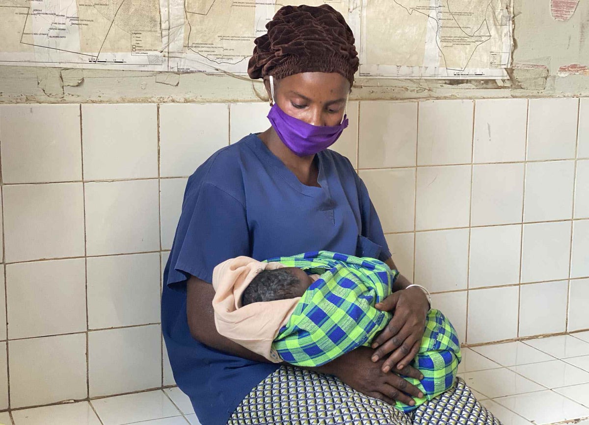 A mother holds her newborn baby at a health facility in Senegal. 