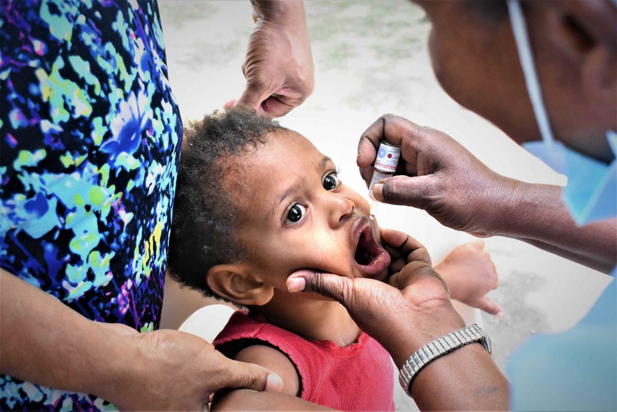 Child getting oral vaccine