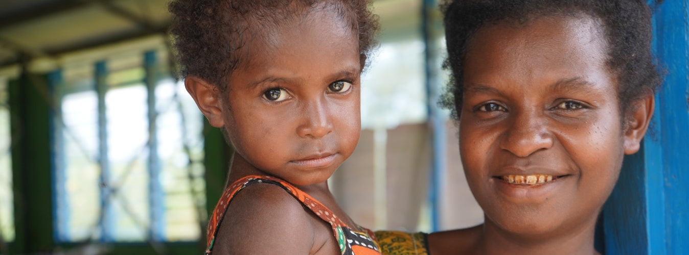 A mother in Papua New Guinea holding her child