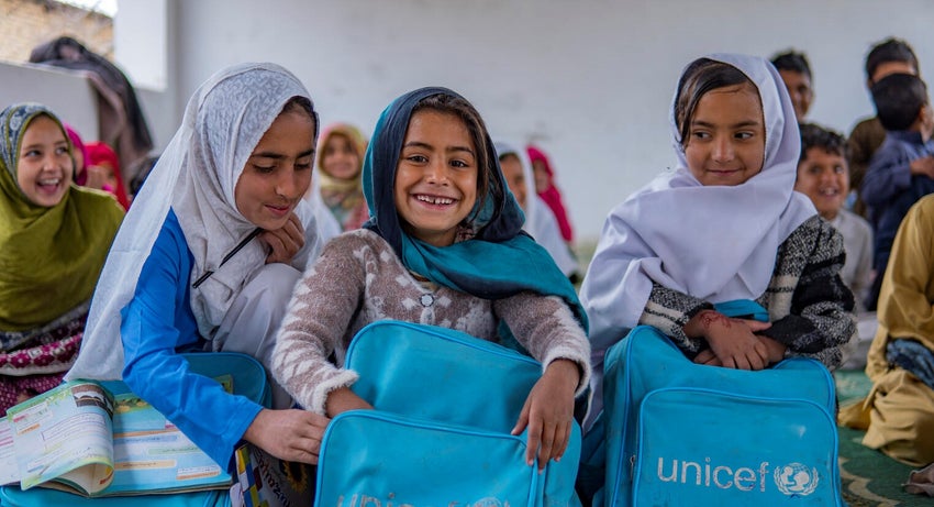 A group of Pakistan girls attend school inside a makeshift classroom after the floods devastated their communities. 