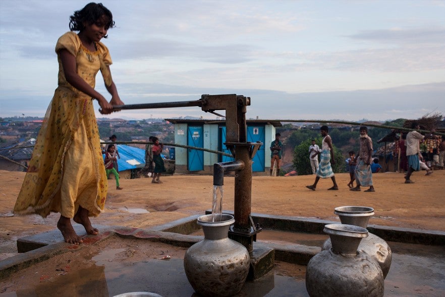 A girl draws safe water from a pump in Kutupalong. 