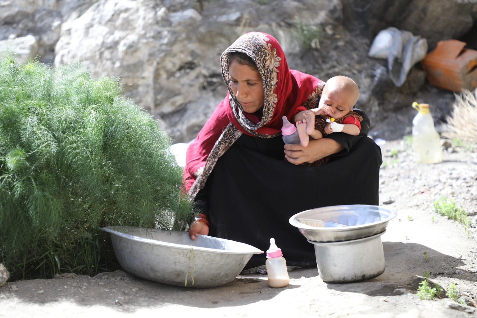 An Afghanistan mother holding her baby who is suffering from malnutrition