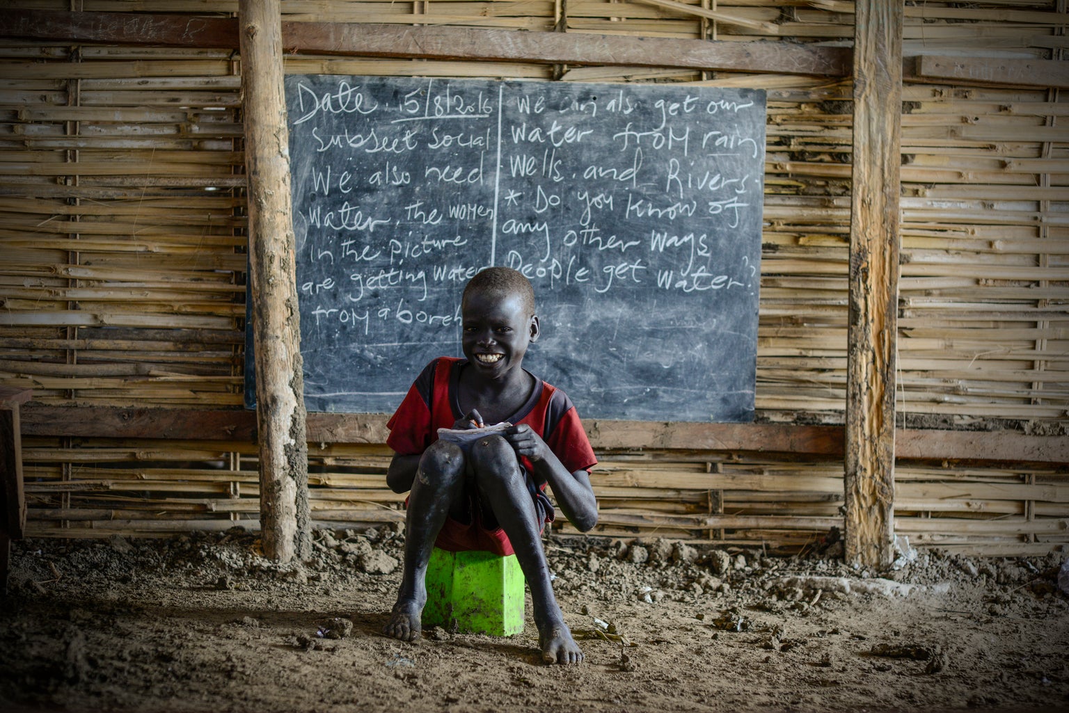 Mawal, 10, brings to school with him the remains of an unknown plastic toy to sit on in class.
