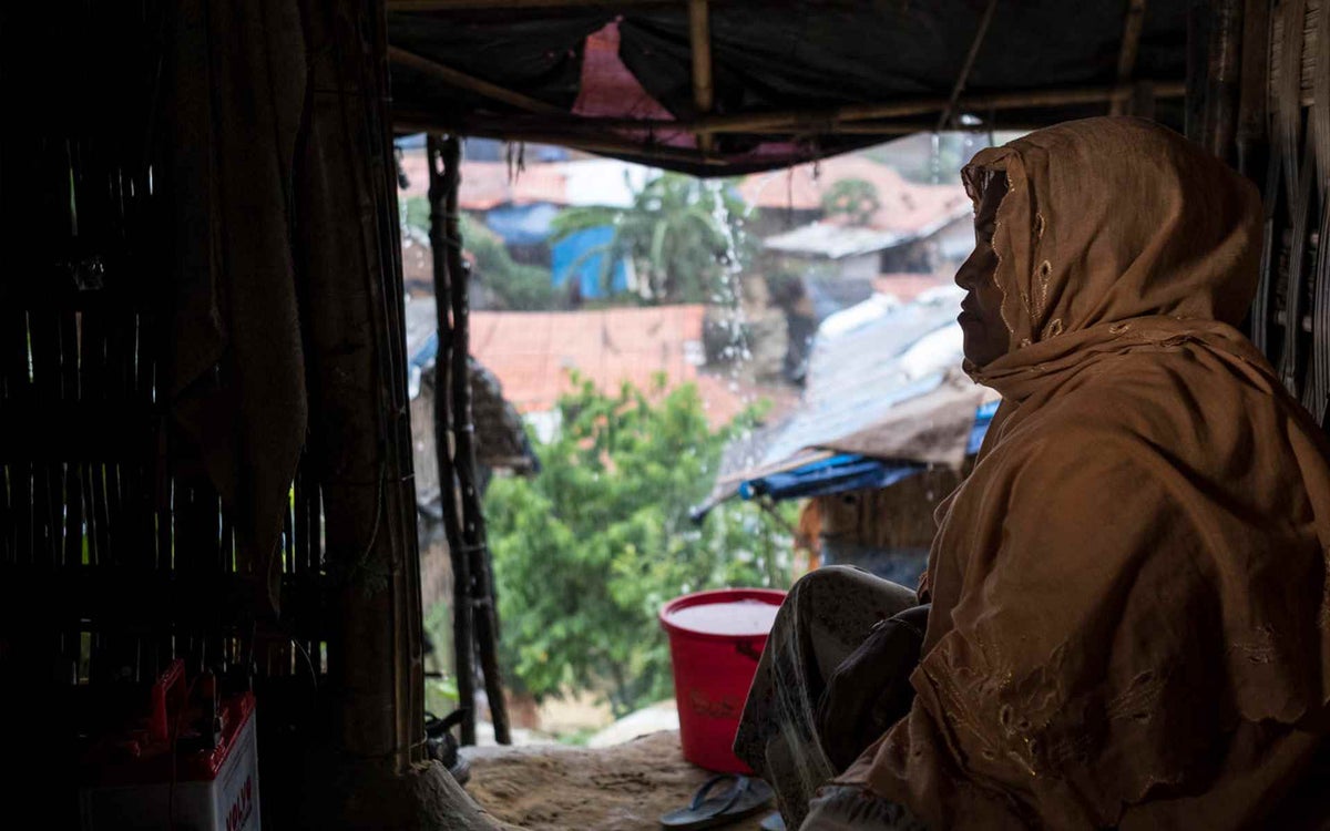 Halima, 36, sits in the doorway of her plastic-and-bamboo house in the Kutapalong camp near Cox’s Bazar.