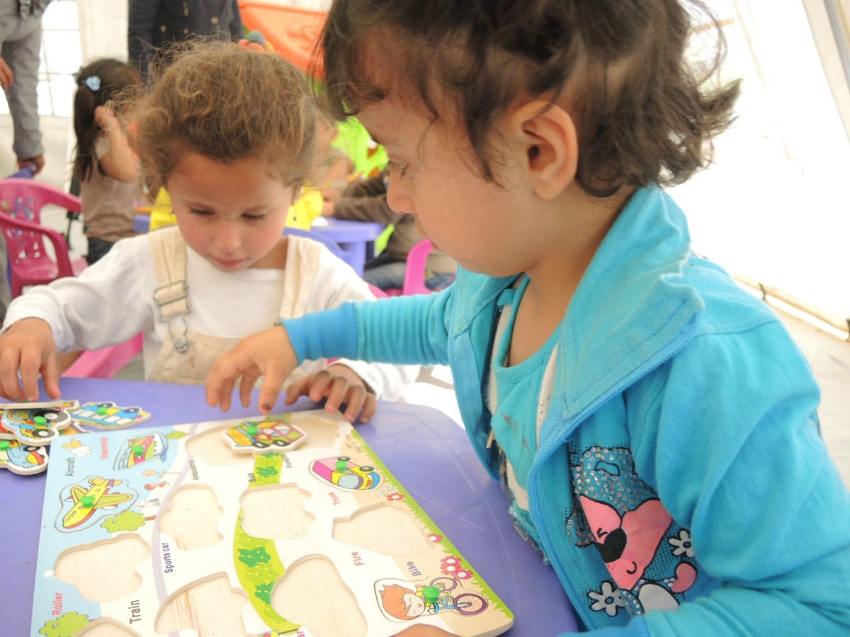 Islam and Shahed, both 3, play quietly in a UNICEF-led program to provide safe learning spaces for pre-school aged children. 