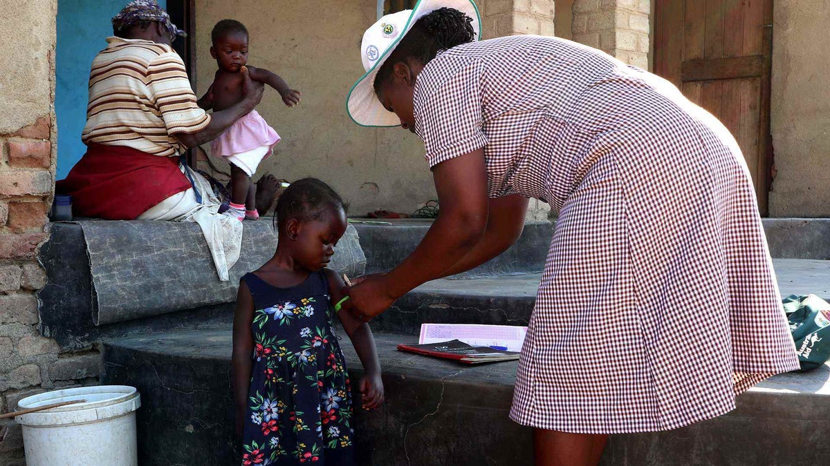 This village health worker visits the community every day to check on mothers and children, including talking to mothers and families about the importance of safe delivery at health facilities. 