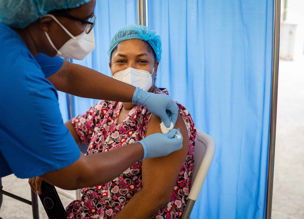 Neonatal nurse Marie Myriam receives her COVID-19 vaccine in Haiti.