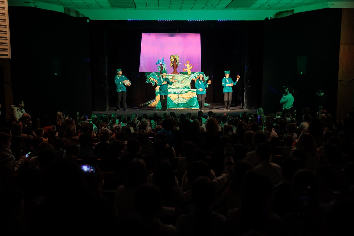 A puppet show happening on a dark stage.