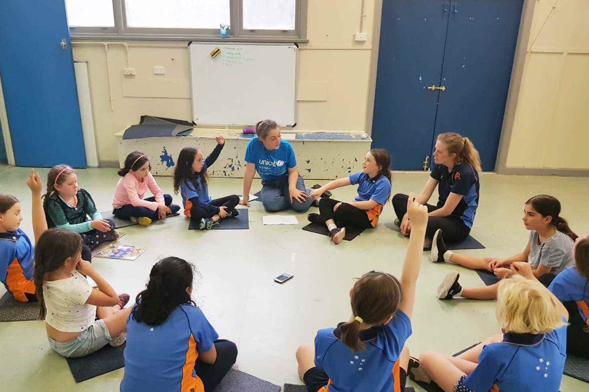Eva listening to children from Girl Guides in Victoria. 