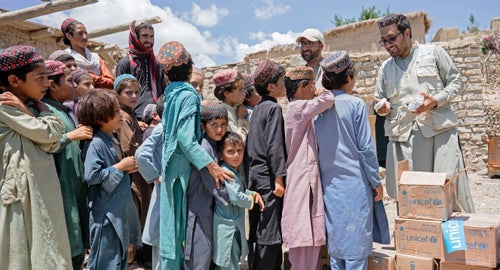 Afghani children lining up to receive soap