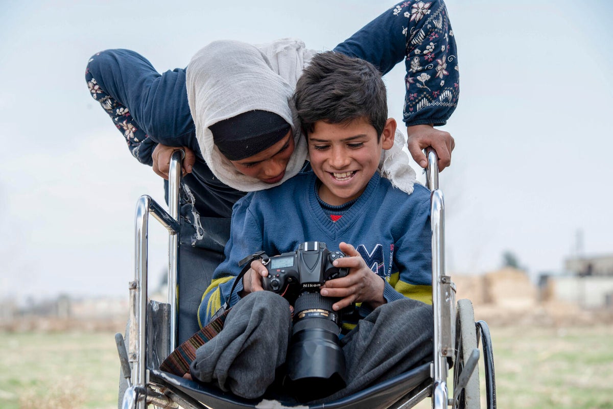 Two Syrian children looking at the camera of a photgrapher