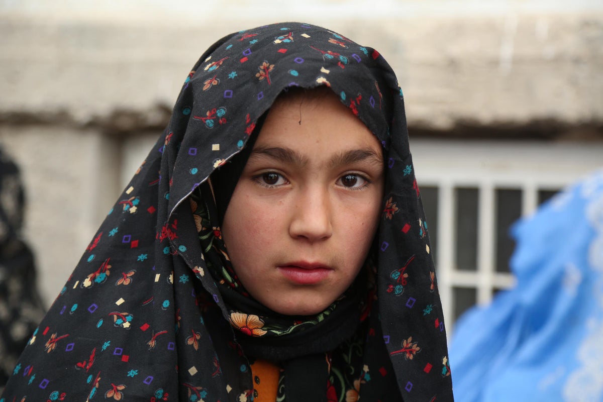 A young girl looks at the camera.