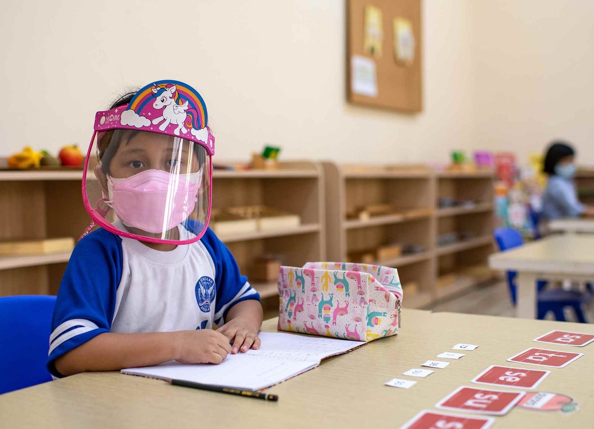 Aurora, five, attends class for the first time since the pandemic began in East Jakarta, Indonesia.