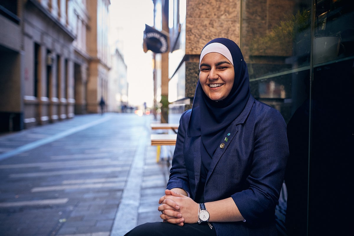 A young woman smiles happily to the camera