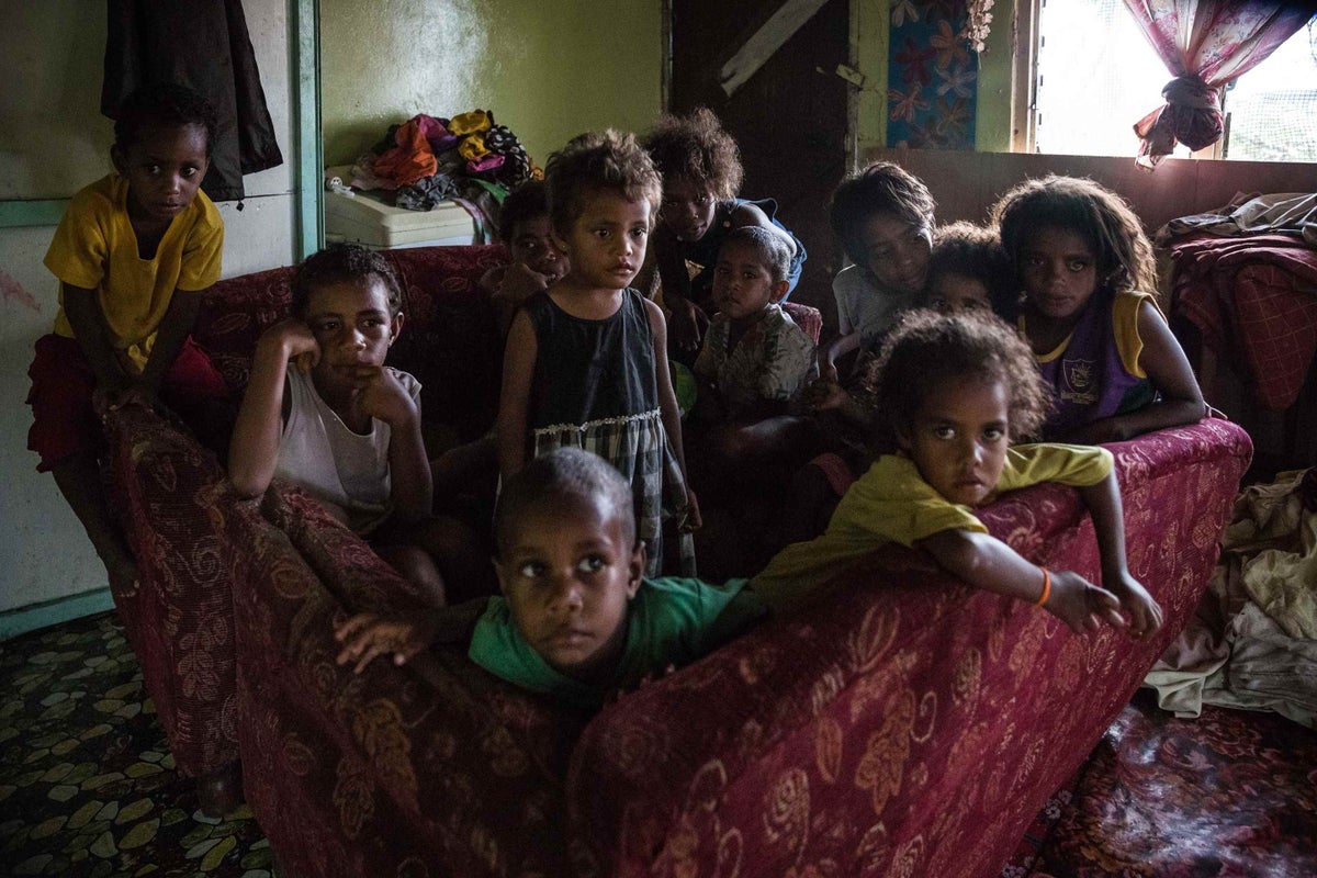 These children coped with Cyclone Winston by making a safe space with two sofas. They huddled in it through the night of the cyclone.