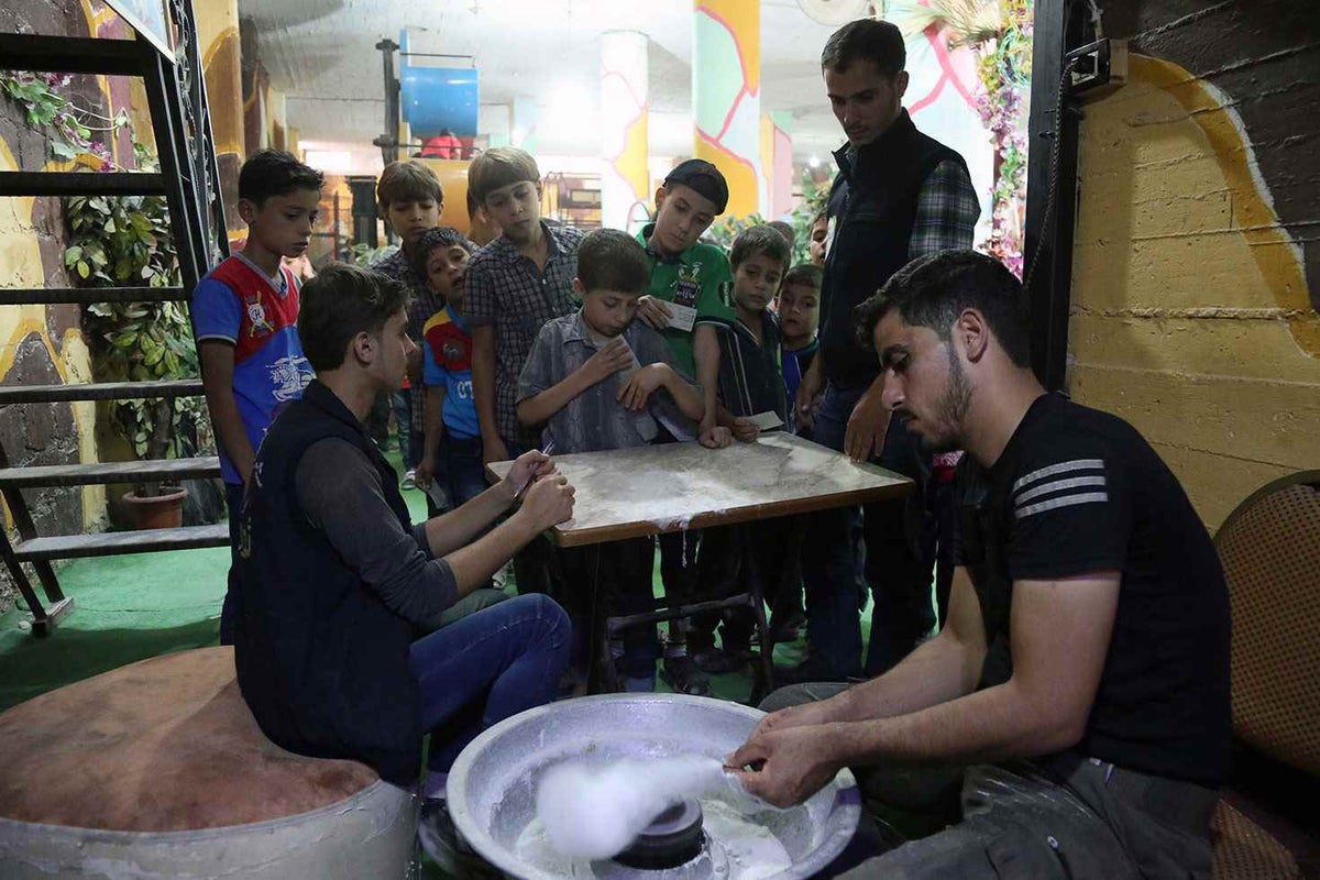 As children wait in line for fairy floss, another six million wait for humanitarian aid, uncertain of when they'll be able to play safely outside, let alone when the war will end