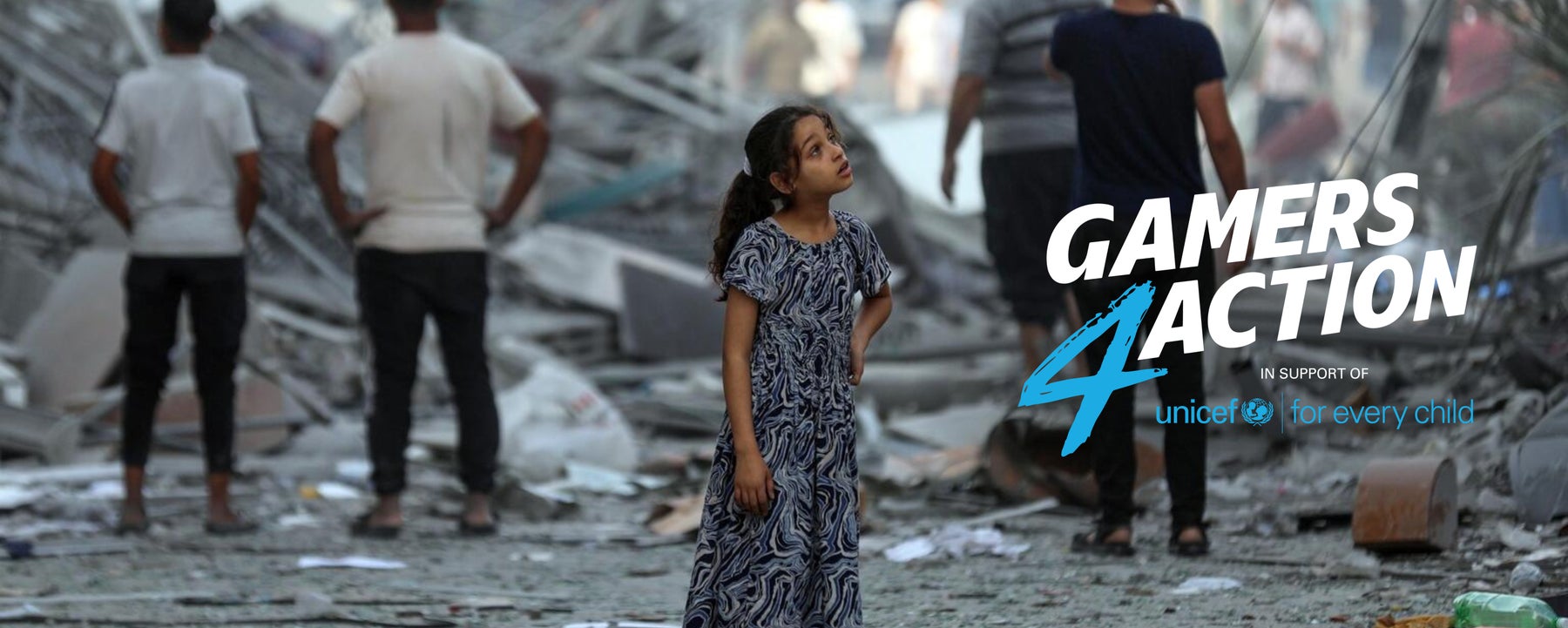 A young girl looking up and standing on the damaged streets of Gaza.