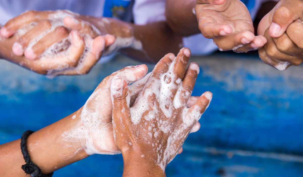 Children in Timor-Leste wash their hands at school, using a facility previously donated by UNICEF