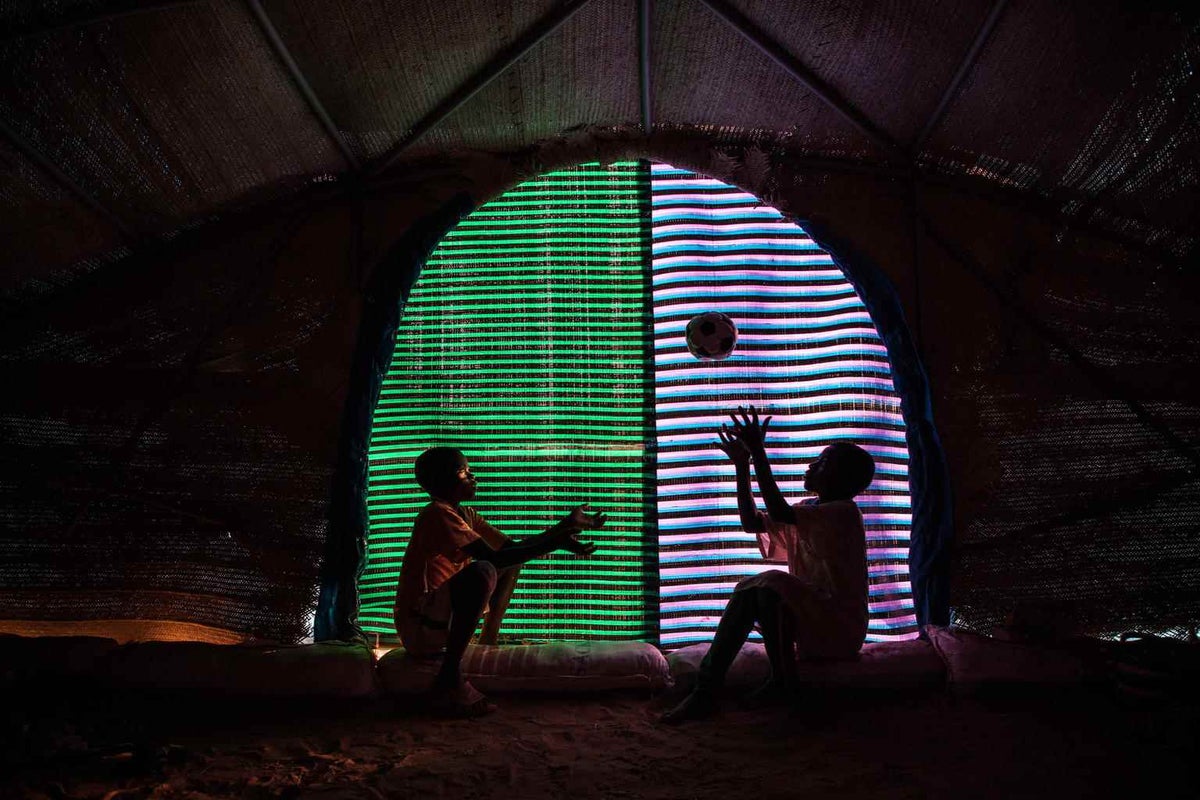 Two boys play in their tent in Burkina Faso. 
