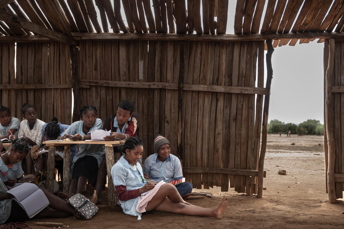 High school students in Madagascar study for an exam in a classroom that has no windows or doors.