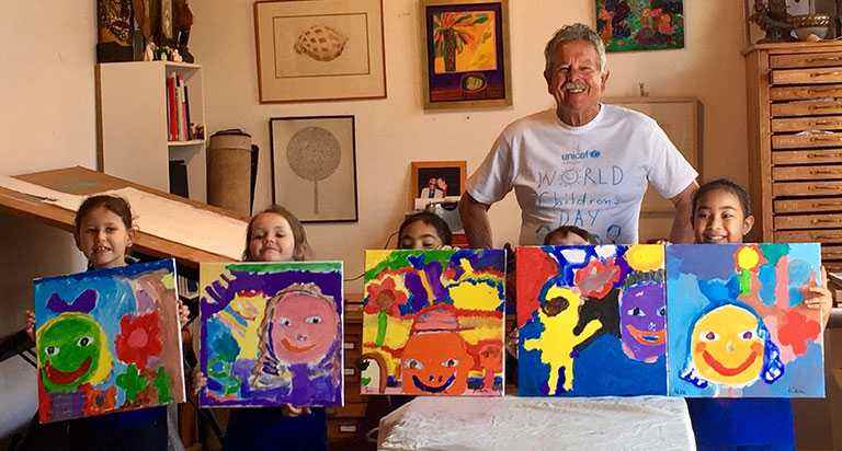 Ken Done with Aussie kids and their self portraits painted for World Children's Day 2017