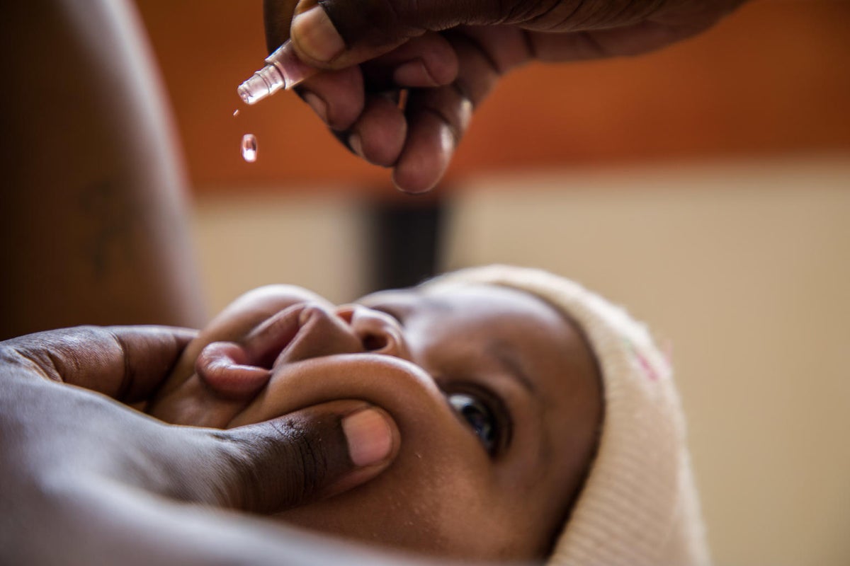 A baby is receiving a droplet vaccine.