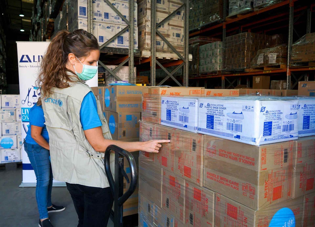 UNICEF Australia International Program Coordinator inspects PPE supplies at a warehouse in Sydney.