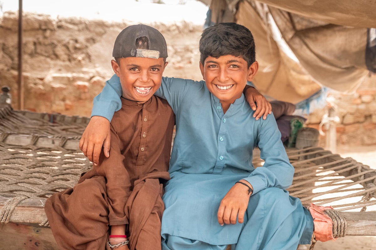 Two young boys from Pakistan smiling at the camera