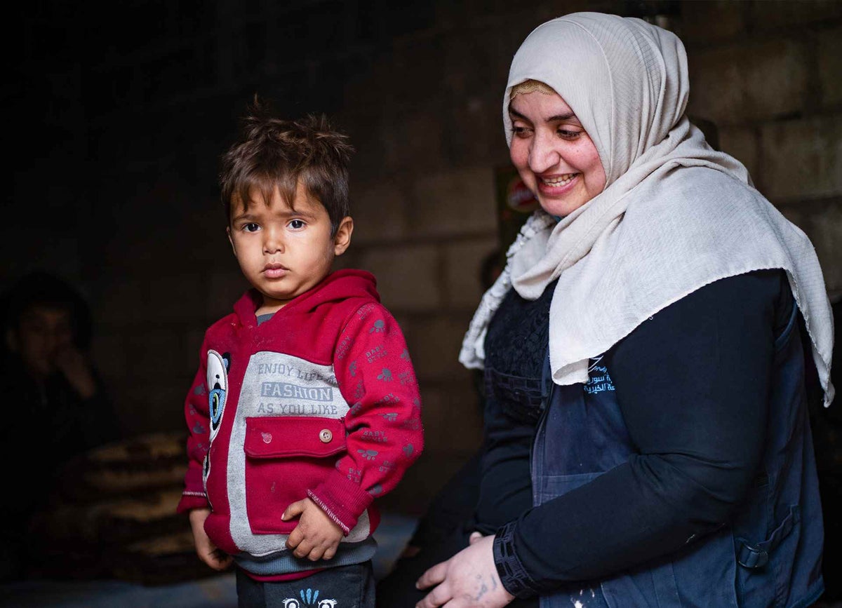Ruqaya, with three-year-old Alaa, one of the children she helped to reunite with his family in northeast Syria. 