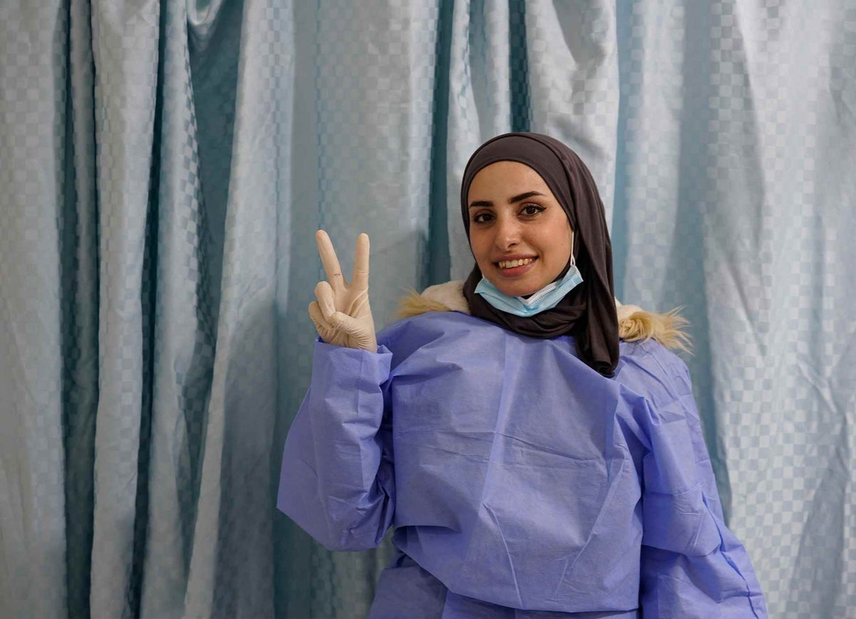 Hanadi, a Jordanian nurse with the Ministry of Health gives the ‘V for Vaccinated’ sign