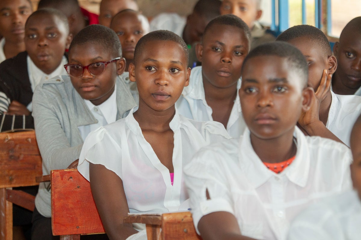 A girl sitting at her desk in a classroom.