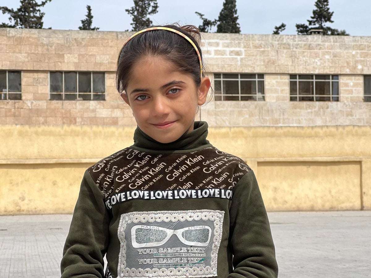 A young girl smiles at the camera