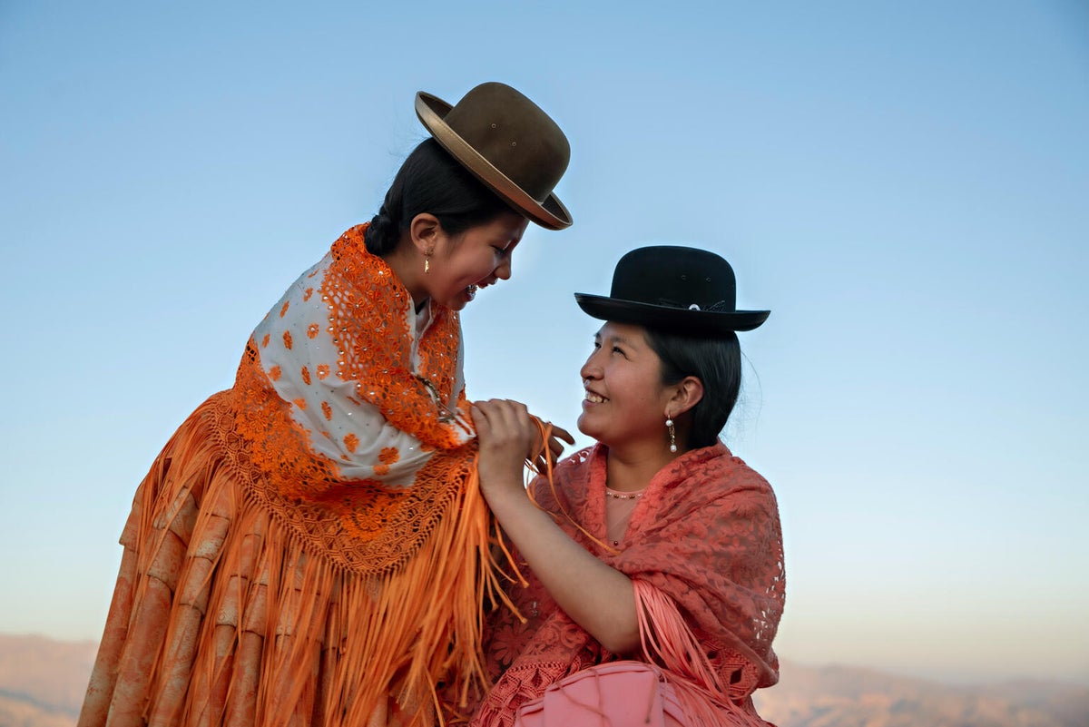 A woman and her daughter laugh together in Bolivia.