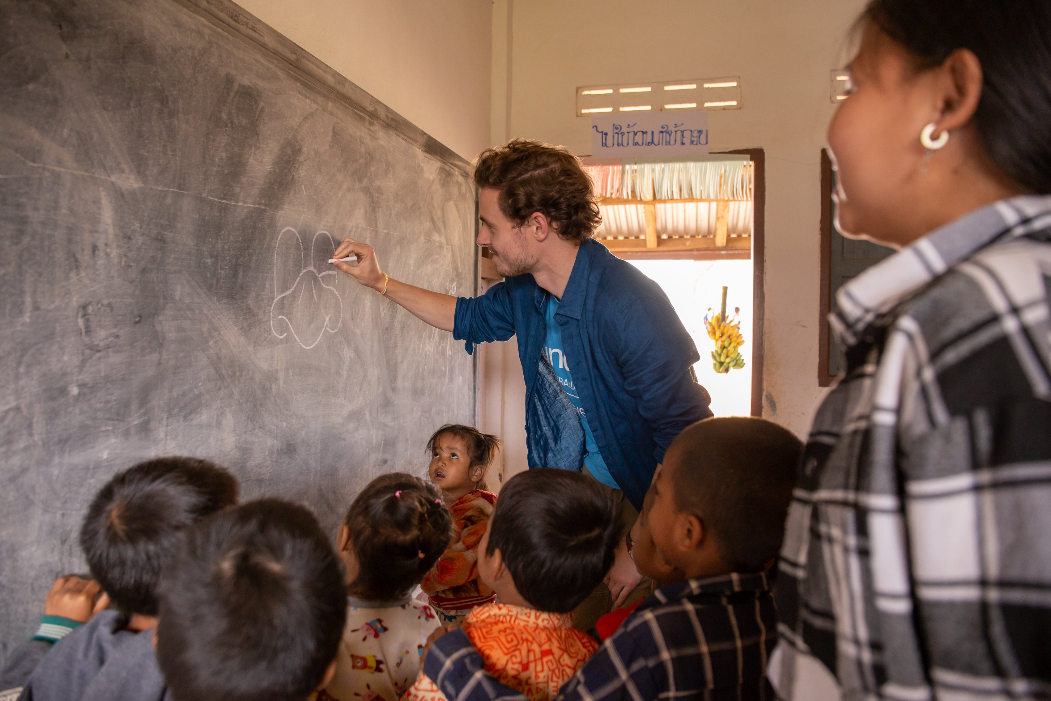 UNICEF Australia Ambassador, Callan McAuliffe, engages in lessons with the children.