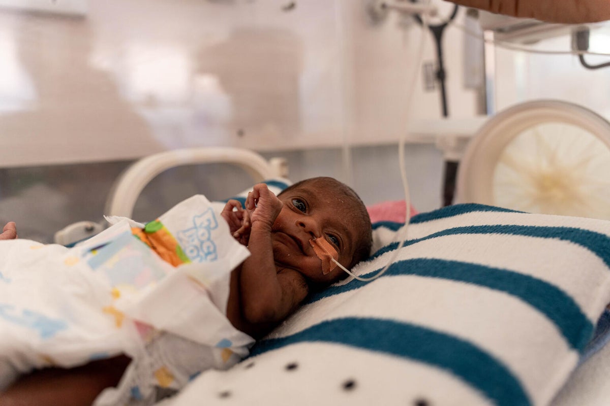 A newborn in an incubator.