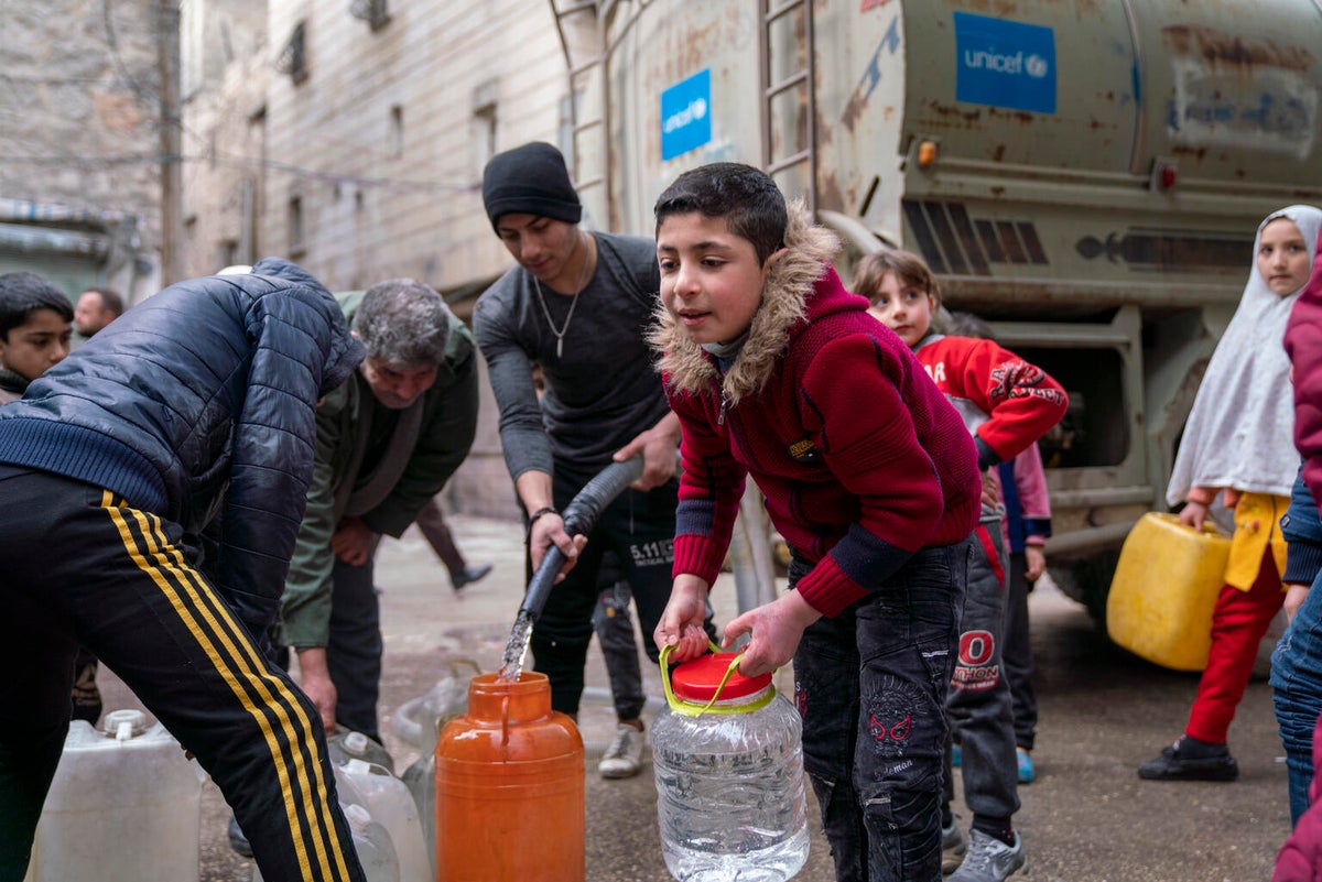 Boy collects drinking water from a UNICEF truck