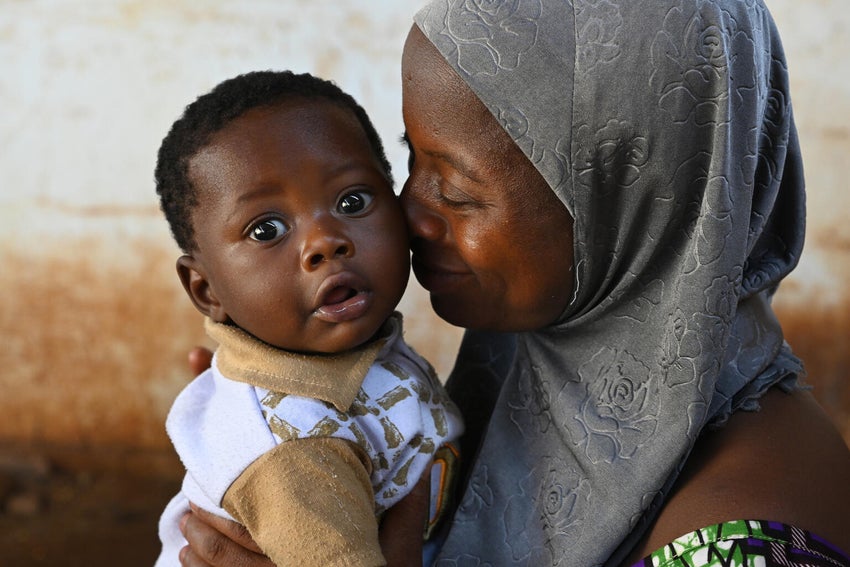A mother holds her baby at a UNICEF-supported health center in Burkina Faso.