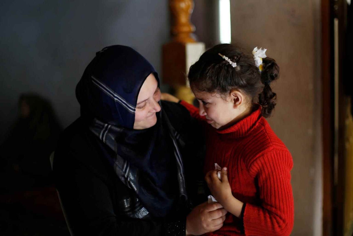  
Neveen Barakat comforts her six year-old daughter Rosol in the Gaza Strip. 