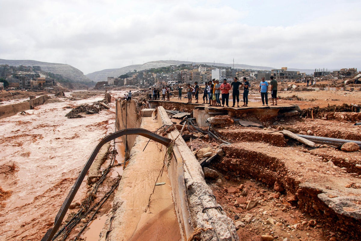 People look at the damage caused by floods in Derna, eastern Libya, on 11 September, 2023.