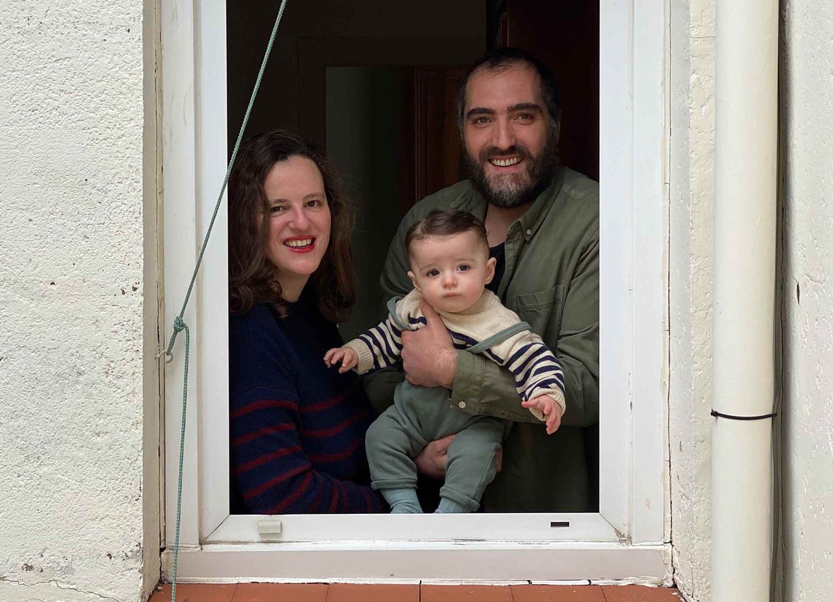 León and his parents watching the daily puppet show put on by their neighbours during the COVID-19 lockdown to entertain the seven-month-old baby.