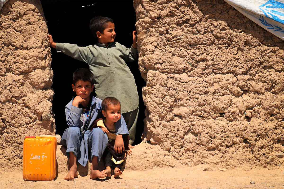 Boys stand in doorway to a shelter