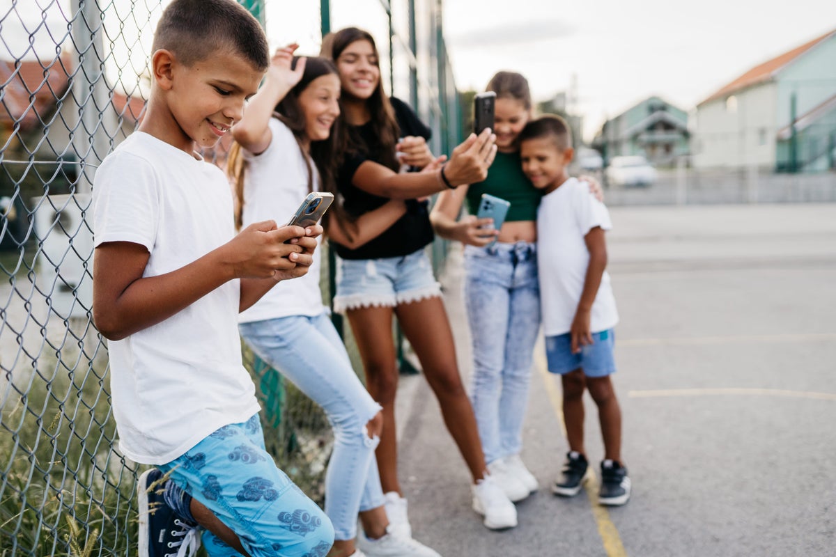 Teens looking at their digital devices