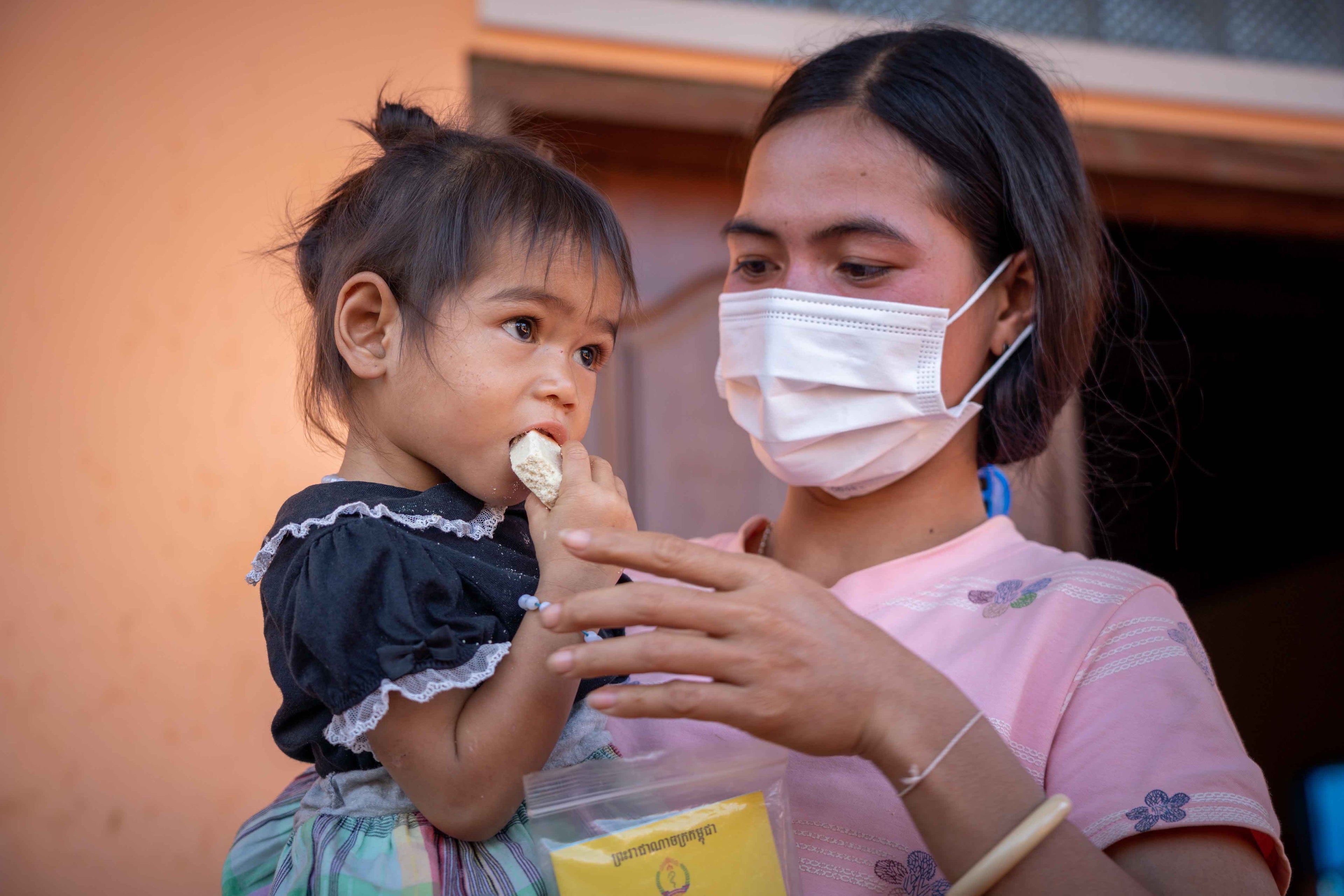 Mother feeding child in Cambodia 